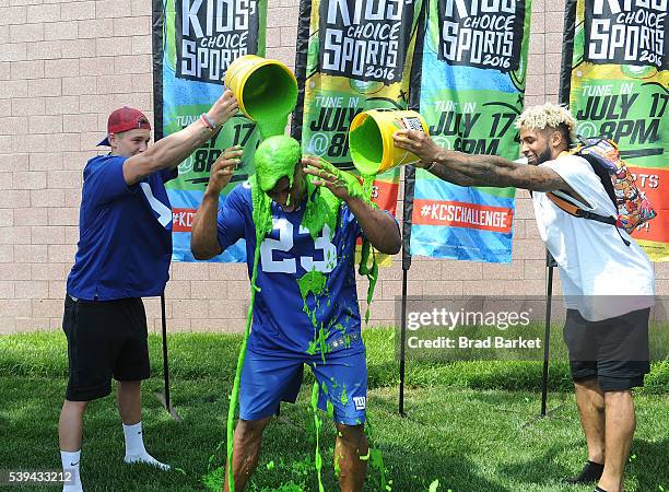 New York Giant Rashad Jennings is slimed by his team mate Bradley Wing and Odell Beckham Jr.Êduring the Nickelodeon And The New York Giants Host...