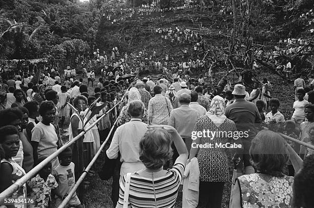 The royal party, led by Queen Elizabeth and Prince Philip, make their way to a display of land diving during a visit to Pentecost Island, Vanuatu,...