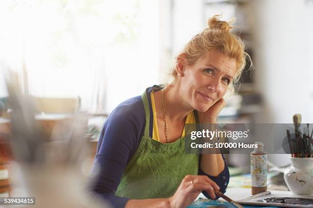 portrait of mature female designer in her studio - 45 year old woman stock pictures, royalty-free photos & images