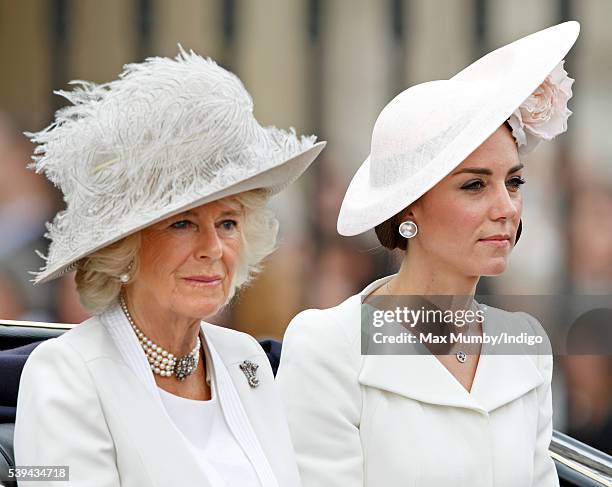 Camilla, Duchess of Cornwall and Catherine, Duchess of Cambridge travel down The Mall from Buckingham Palace in a horse drawn carriage during...