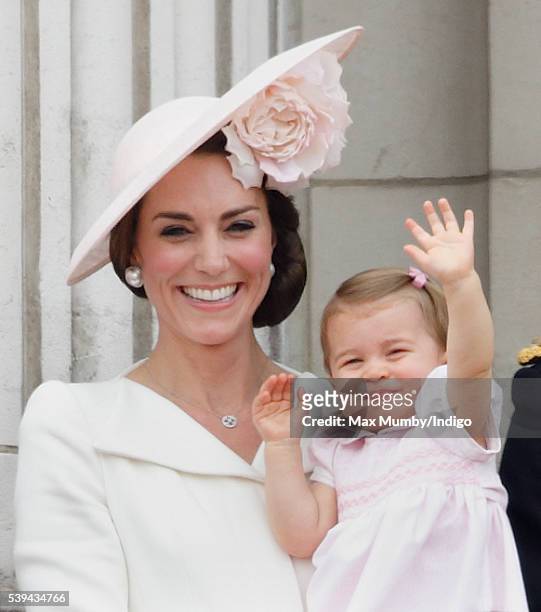 Catherine, Duchess of Cambridge and Princess Charlotte of Cambridge stand on the balcony of Buckingham Palace during Trooping the Colour, this year...