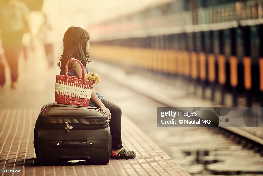 Little girl waiting in a railway station