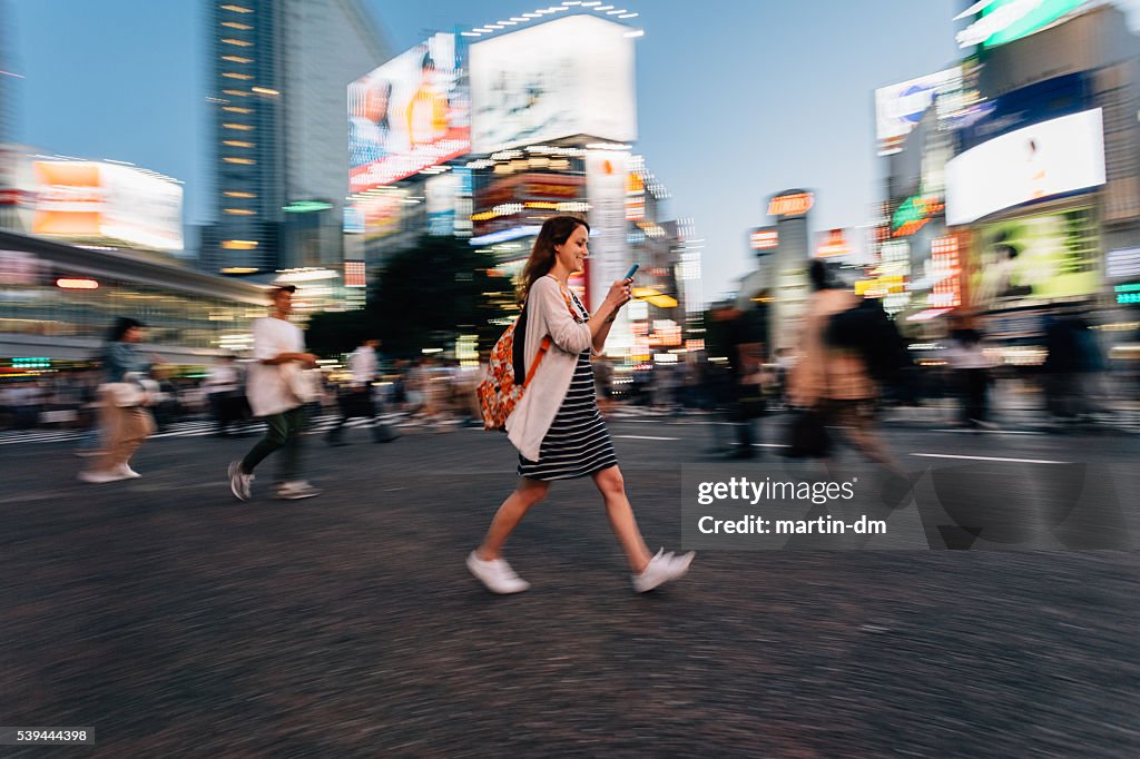 Woman on the phone at Shibuya crossing in Tokyo