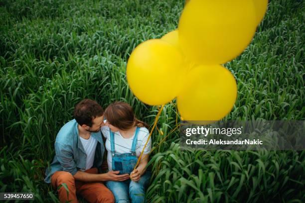 the tree of us - balloon stomach stockfoto's en -beelden