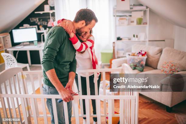 assembling a baby crib - pregnant couple stock pictures, royalty-free photos & images