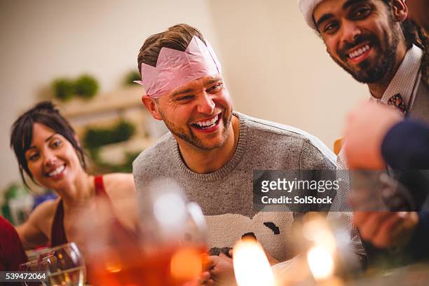 sharing christmas jokes - christmas crackers stock pictures, royalty-free photos & images