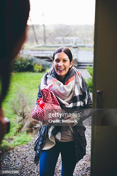 visitor arriving with a gift - neighbors bildbanksfoton och bilder