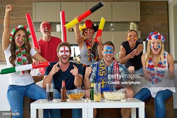 cheering international soccer fans - internationaal voetbalevenement stockfoto's en -beelden