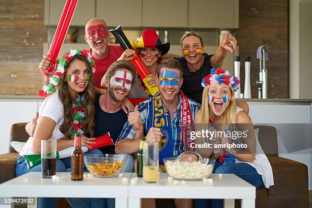 sports fans in front of tv - france v sweden international friendly stockfoto's en -beelden