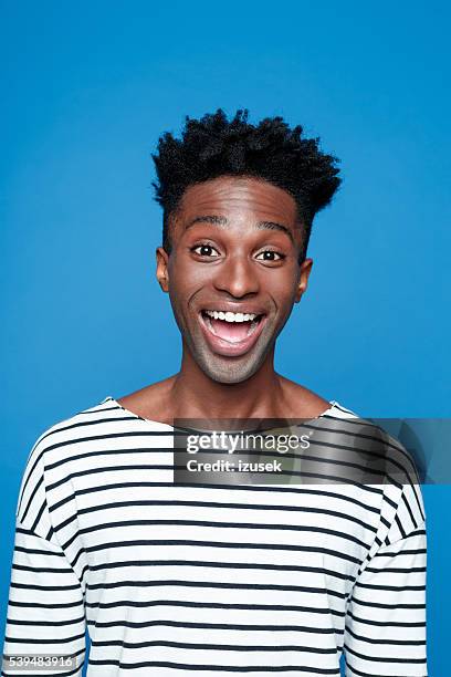 excited afro american young man - word of mouth stock pictures, royalty-free photos & images