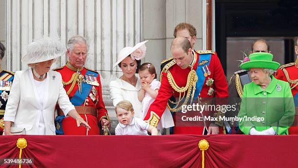 Prince George of Cambridge peers over the balcony of Buckingham Palace as Camilla, Duchess of Cornwall, Prince Charles, Prince of Wales, Catherine,...