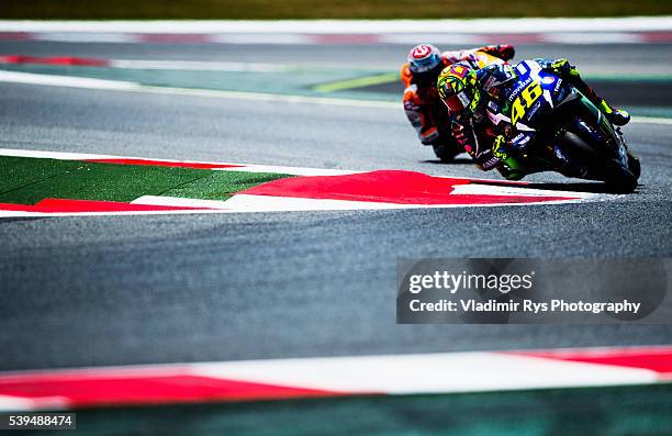 Valentino Rossi of Italy and Movistar Yamaha MotoGP leads Marc Marquez of Spain and Repsol Honda Team during the MotoGP of Catalunya at Circuit de...