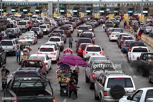 Street vendors sell wares as vehicles wait in line for re-entry into the United States of America on the Mexican side of the San Ysidro port of entry...