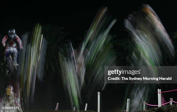 Blur of motion as competitors navigate the undulating terrain during competition at the Supercross Masters Grand Final held at a packed Central Coast...