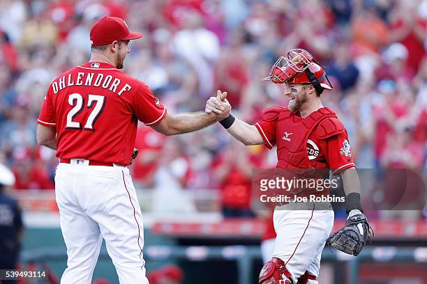 Tucker Barnhart and Ross Ohlendorf of the Cincinnati Reds celebrate after the final out of the game against the Oakland Athletics at Great American...