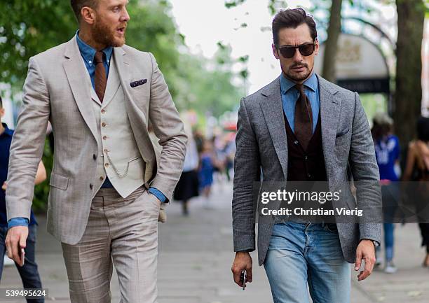 Joe Ottaway wearing a beige suit and model David Gandy wearing denim jeans and grey jacket outside Tiger of Sweden during The London Collections Men...