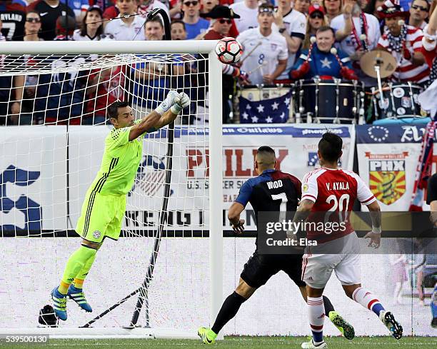 Justo Villar of Paraguay stops a shot in the first half as Bobby Wood of the United States and Victor Ayala of Paraguay wait for the rebound during...