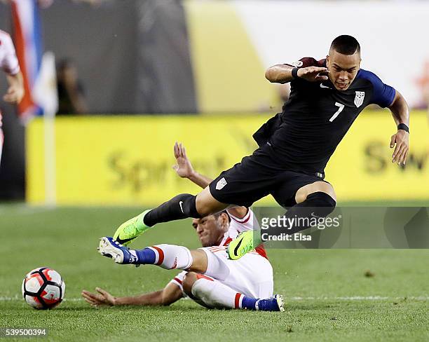 Bobby Wood of United States is tripped by Miguel Samudio of Paraguay during the Copa America Centenario Group C match at Lincoln Financial Field on...