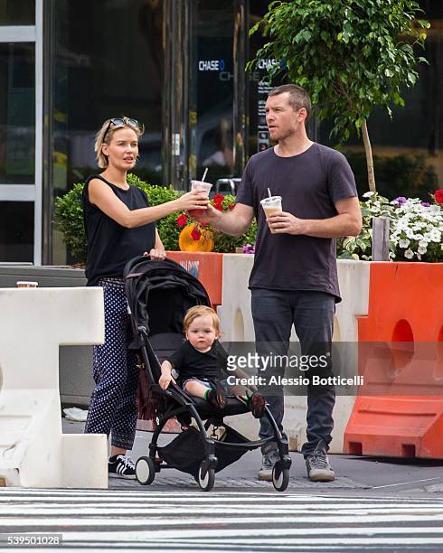 Sam Worthington with Lara Bingle and their baby Rocket Zot are seen buying fruit shakes from a street vendor in TriBeCa on June 11, 2016 in New York,...