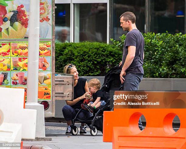 Sam Worthington with Lara Bingle and their baby Rocket Zot are seen buying fruit shakes from a street vendor in TriBeCa on June 11, 2016 in New York,...