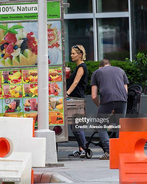 Sam Worthington with Lara Bingle and their baby Rocket Zot are seen buying fruit shakes from a street vendor in TriBeCa on June 11, 2016 in New York,...