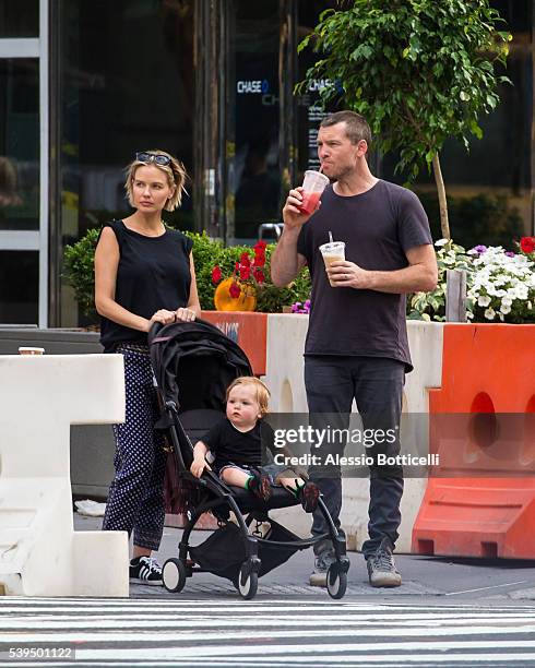 Sam Worthington with Lara Bingle and their baby Rocket Zot are seen buying fruit shakes from a street vendor in TriBeCa on June 11, 2016 in New York,...