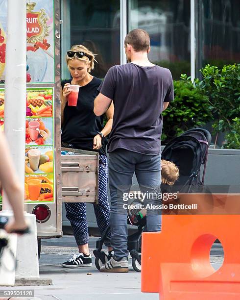 Sam Worthington with Lara Bingle and their baby Rocket Zot are seen buying fruit shakes from a street vendor in TriBeCa on June 11, 2016 in New York,...