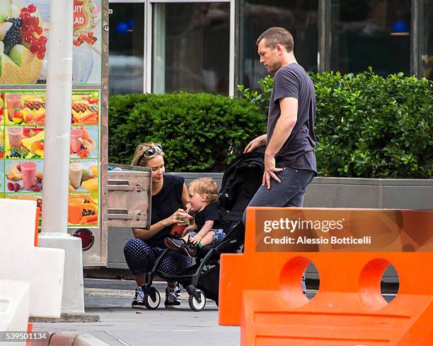 Sam Worthington with Lara Bingle and their baby Rocket Zot are seen buying fruit shakes from a street vendor in TriBeCa on June 11, 2016 in New York,...