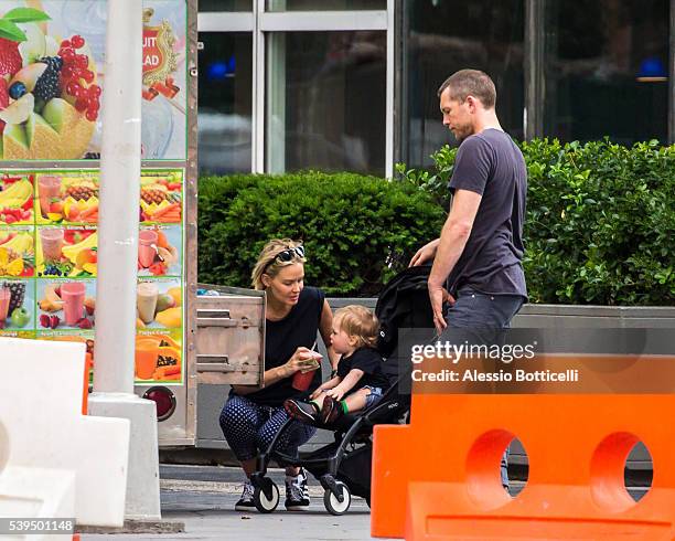 Sam Worthington with Lara Bingle and their baby Rocket Zot are seen buying fruit shakes from a street vendor in TriBeCa on June 11, 2016 in New York,...