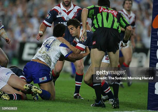 Roosters player Anthony Minichiello tries to hold back the Bulldogs attack at the Grand Final between the Sydney Roosters and the Canterbury...