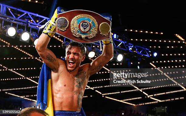 Vasyl Lomachenko holds the championship belt after defeating Roman Martinez by knock out during the fifth round of their Junior Lightweight WBO World...