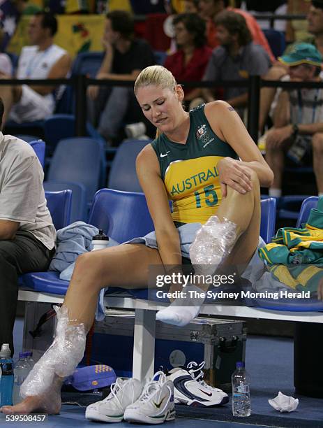 Lauren Jackson receives treatment and ice to her ankles and shins - then lets the photographers know shes ok during the Australia vs Greece womens...