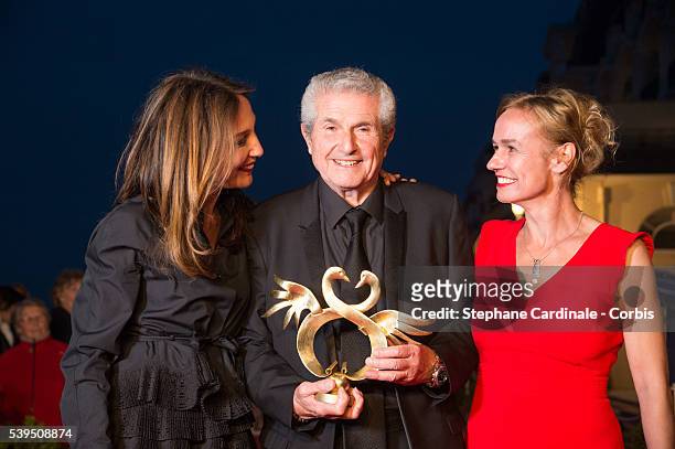 Director Claude Lelouch poses with his 'Sawnn Award' for a Tribute for 50 years anniversary of 'Un homme et Une femme' movie, with actresses Elsa...