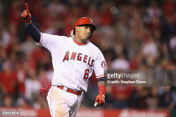 Yunel Escobar of the Los Angeles Angels of Anaheim celebrates as he runs to first after hitting a walk off RBI single in the ninth inning against the...