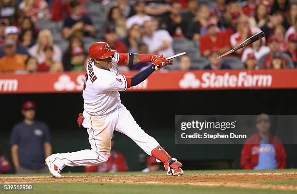 Yunel Escobar of the Los Angeles Angels of Anaheim breaks his bat as he hits a walk off RBI single in the ninth inning against the Cleveland Indians...