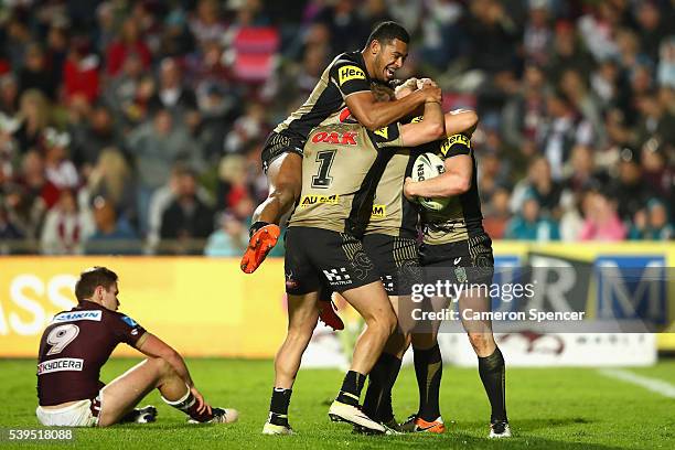 Peter Wallace of the Panthers celebrates scoring a try with team mates during the round 14 NRL match between the Manly Sea Eagles and the Penrith...