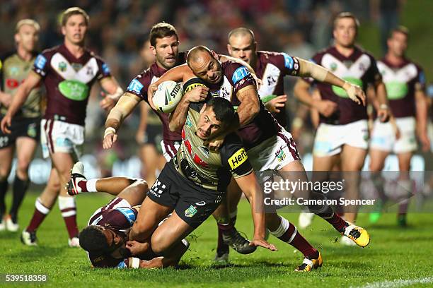 Reagan Campbell-Gillard of the Panthers is tackled short of the tryline during the round 14 NRL match between the Manly Sea Eagles and the Penrith...