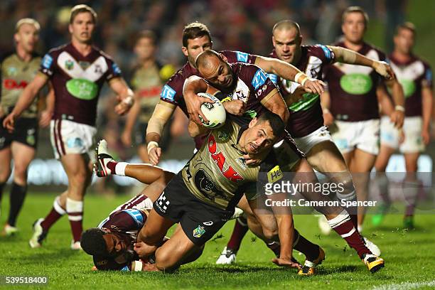 Reagan Campbell-Gillard of the Panthers is tackled short of the tryline during the round 14 NRL match between the Manly Sea Eagles and the Penrith...