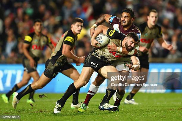 Josh Mansour of the Panthers is tackled during the round 14 NRL match between the Manly Sea Eagles and the Penrith Panthers at Brookvale Oval on June...