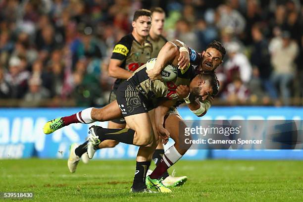 Josh Mansour of the Panthers is tackled during the round 14 NRL match between the Manly Sea Eagles and the Penrith Panthers at Brookvale Oval on June...