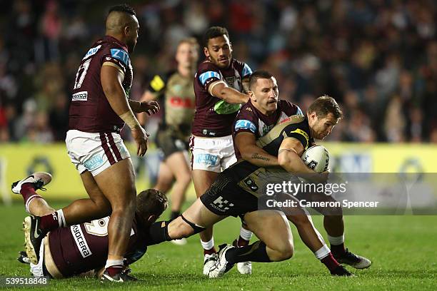 Trent Merrin of the Panthers is tackled during the round 14 NRL match between the Manly Sea Eagles and the Penrith Panthers at Brookvale Oval on June...