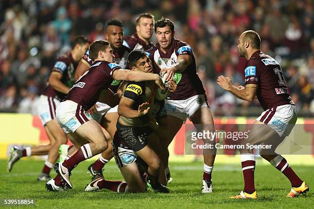 Tyrone Peachey of the Panthers is tackled during the round 14 NRL match between the Manly Sea Eagles and the Penrith Panthers at Brookvale Oval on...