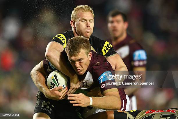 Tom Trbojevic of the Sea Eagles is tackled during the round 14 NRL match between the Manly Sea Eagles and the Penrith Panthers at Brookvale Oval on...