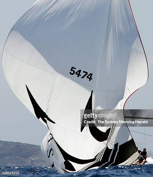 Crewman on board Maserati pulls in the spinaker, 16 December 2004. SMH Picture by CRAIG GOLDING
