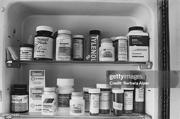 Domestic medicine cabinet containing, amongst other things, Tylenol, Colace, Senokot, Eucerin, Hygroton, Seldane, Microdantin and Natural Made brand...