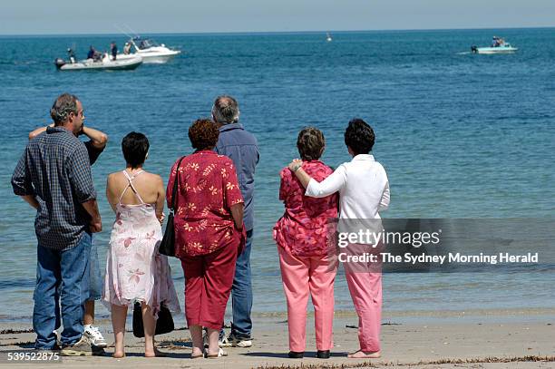 Family members watch surf rescue and police look for the body of Nick Peterson along the shore, 17 December 2004. SMH Picture by DAVID MARIUZ
