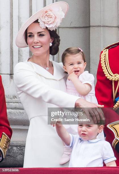 Catherine, Duchess of Cambridge, Princess Charlotte, Prince George stand on the balcony during the Trooping the Colour, this year marking the Queen's...