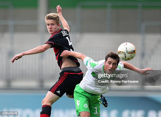 Jan Boller of Leverkusen heads for the ball with with Yari Otto of Wolfsburg during the U17 German Championship Semi Final Second Leg between VfL...