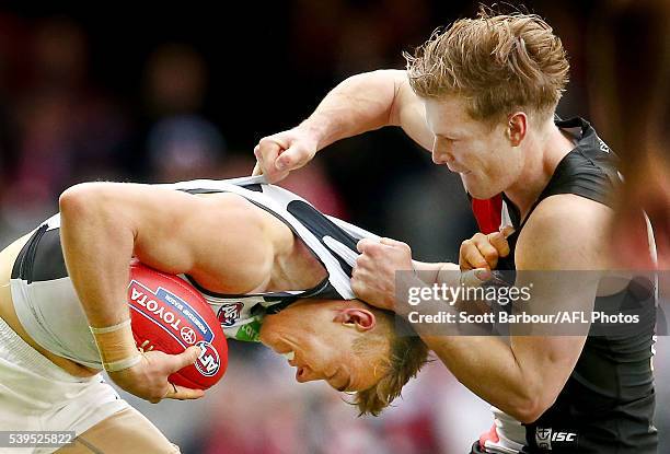 Patrick Cripps of the Blues is tackled by Jack Newnes of the Saints during the round 12 AFL match between the St Kilda Saints and the Carlton Blues...