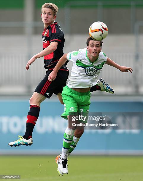 Jan Boller of Leverkusen heads for the ball with with Yari Otto of Wolfsburg during the U17 German Championship Semi Final Second Leg between VfL...